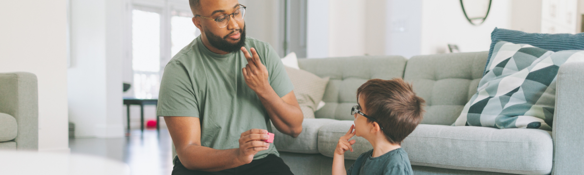 adult signing to a young boy