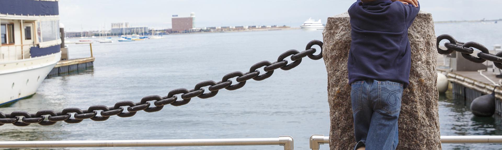 boy looking out at harbor