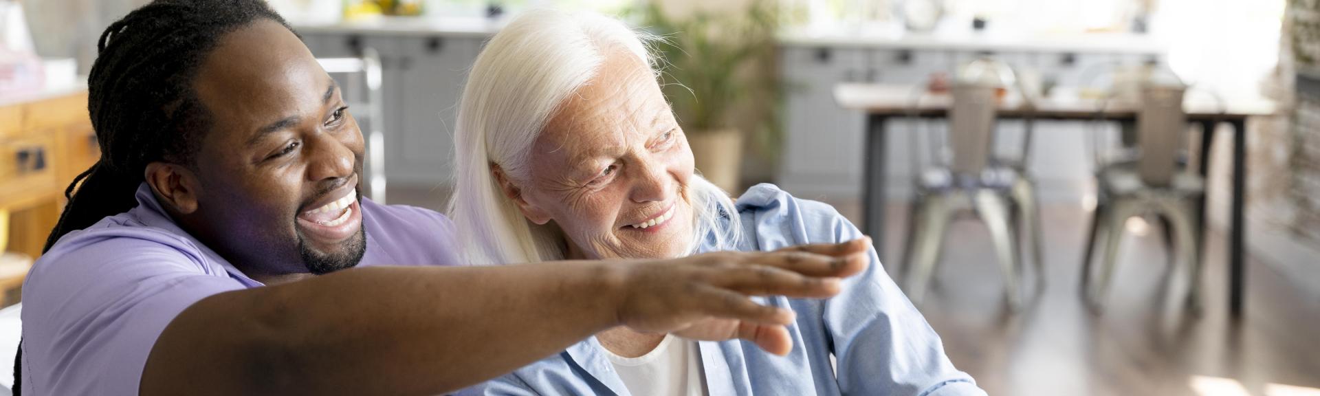 man and senior woman looking outside smiling
