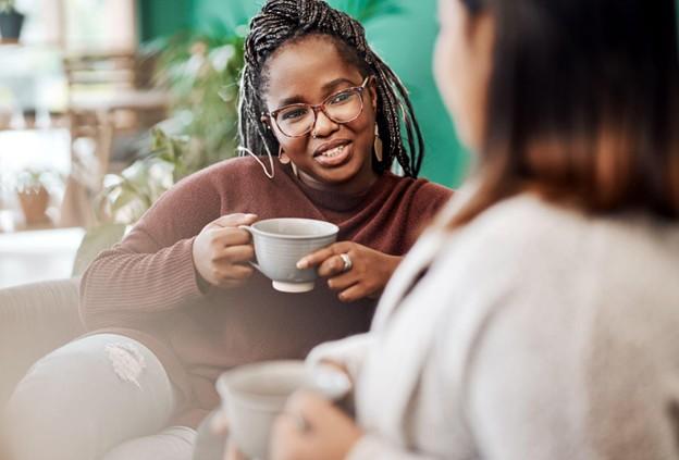 Two women talking and having tea